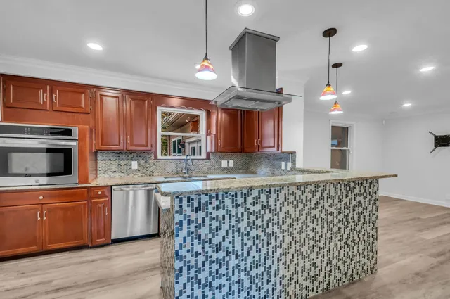 a kitchen with stainless steel appliances granite countertop a sink and a microwave
