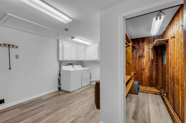 a view of walk in closet with wooden floor