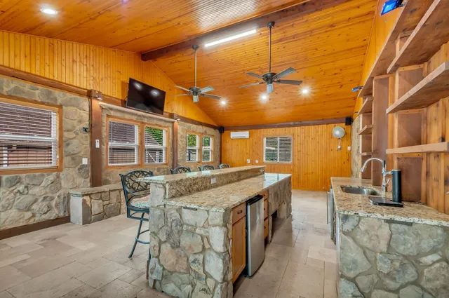 a dinning table and chairs in the patio of a house