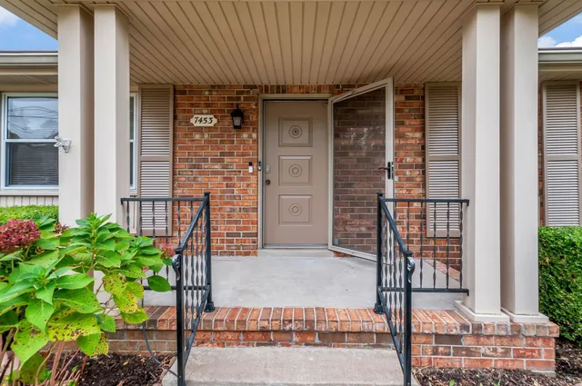a front view of a house with a garden