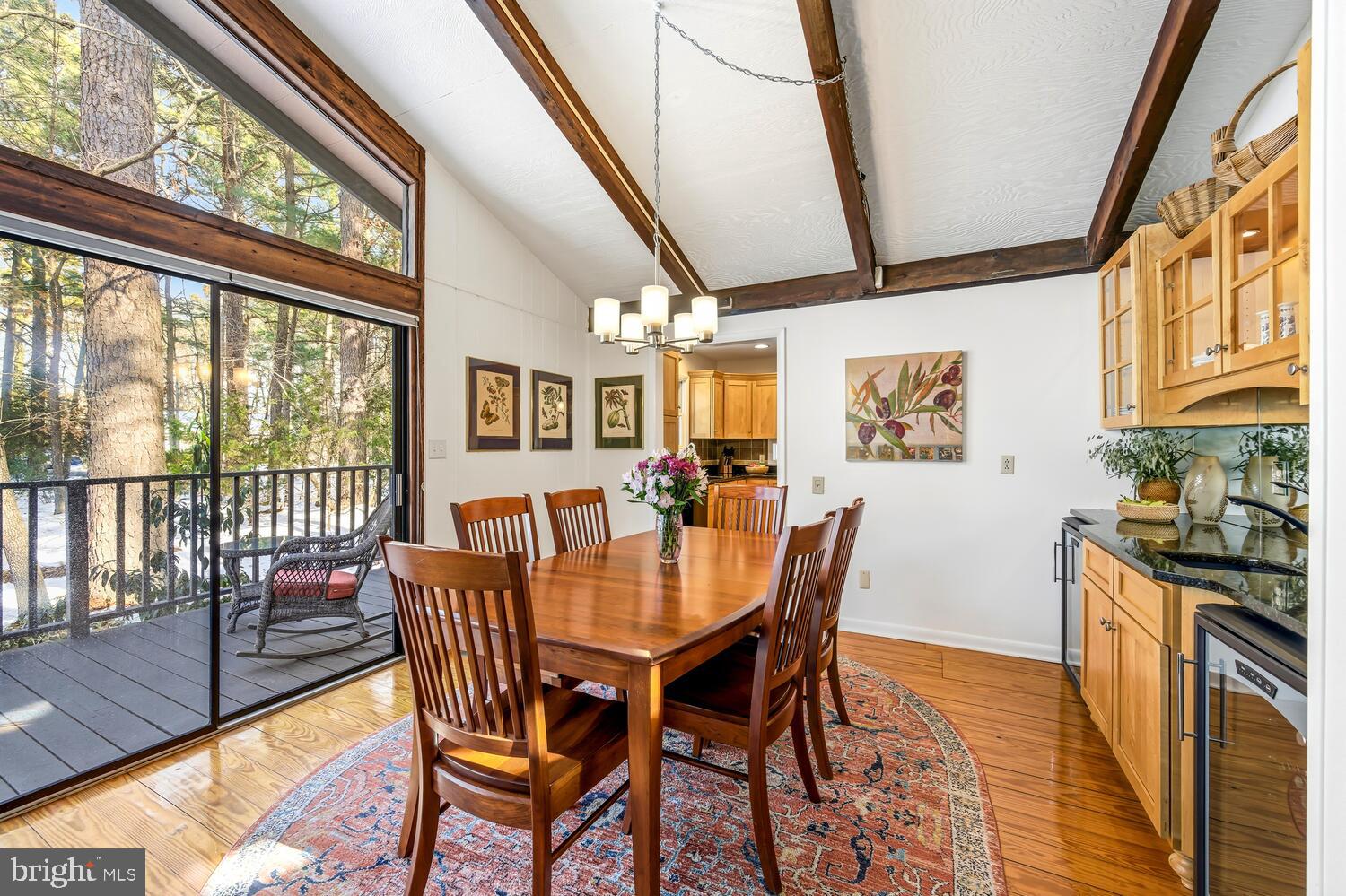 25711 Royal Road Royal Oak, MD 21662 - Photo 17 of 37 a dining room with furniture a rug and wooden floor