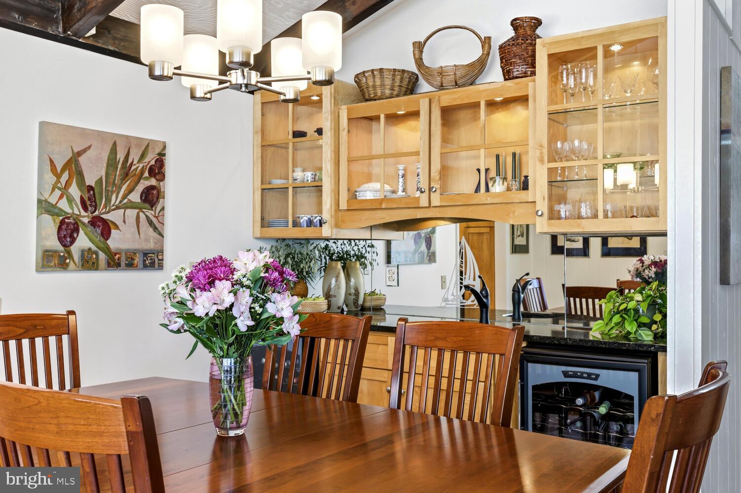 25711 Royal Road Royal Oak, MD 21662 - Photo 18 of 37 a dining room with furniture potted plants and wooden floor