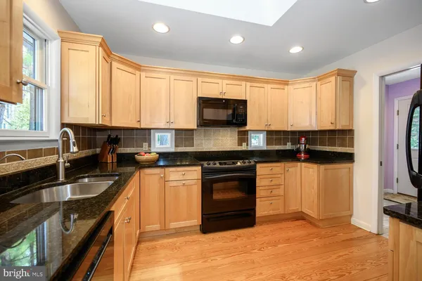 a kitchen with refrigerator and cabinets