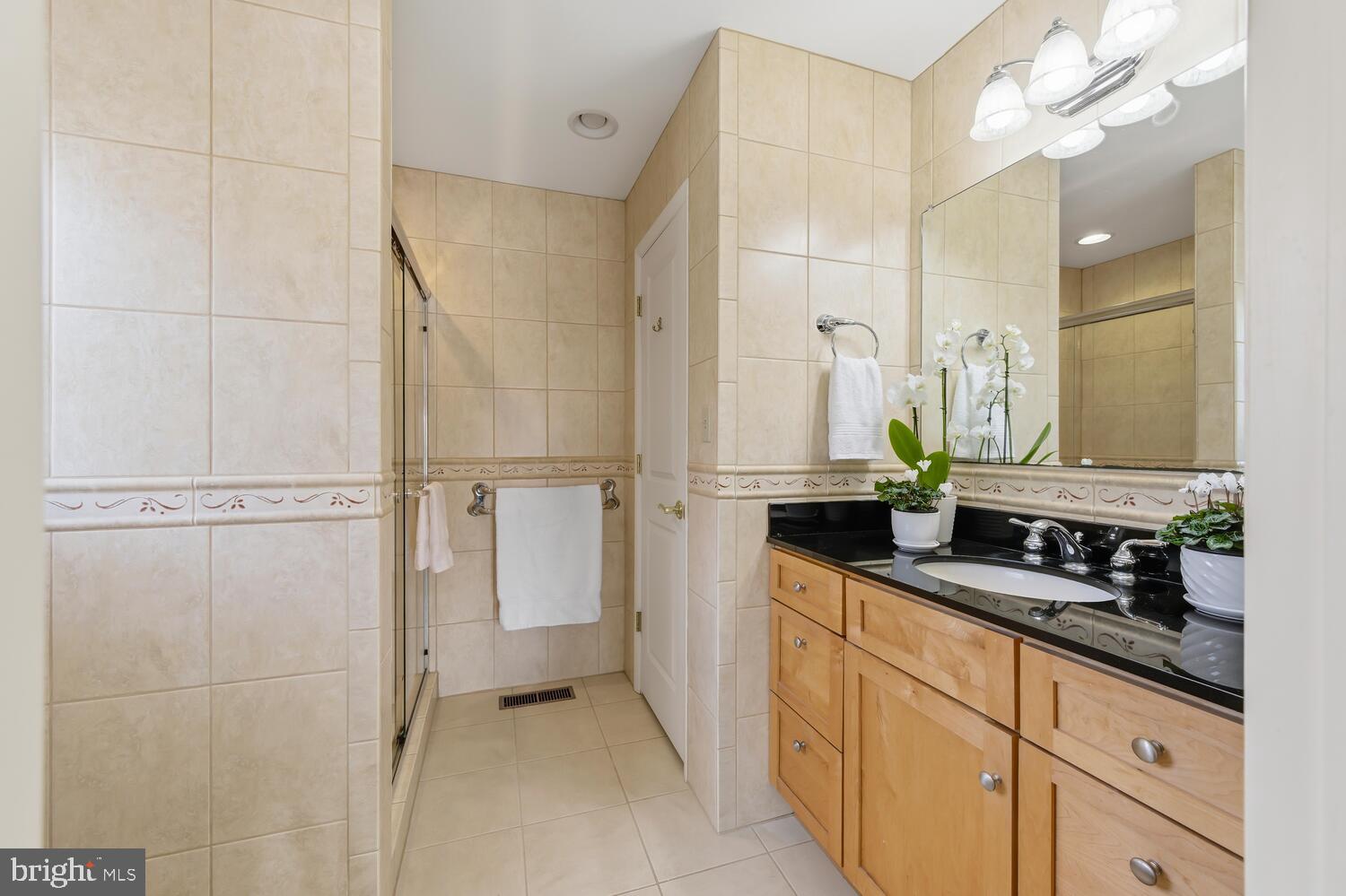 25711 Royal Road Royal Oak, MD 21662 - Photo 29 of 37 a bathroom with a double vanity sink and mirror