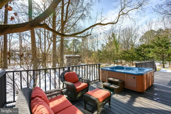 a balcony with wooden floor and furniture