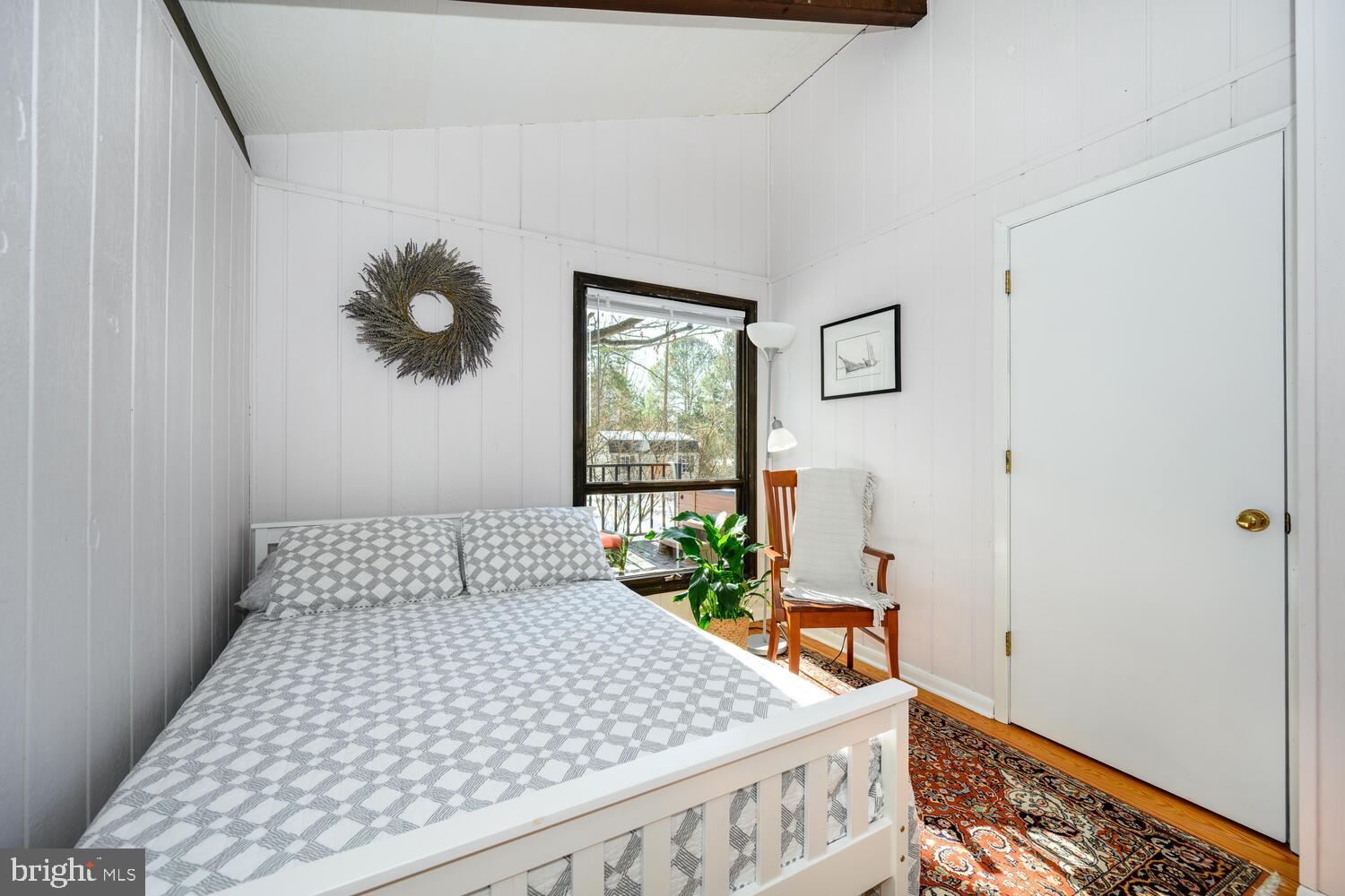 25711 Royal Road Royal Oak, MD 21662 - Photo 32 of 37 a bedroom with a bed and wooden floor