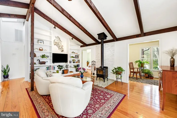 a living room with furniture a flat screen tv and a large window