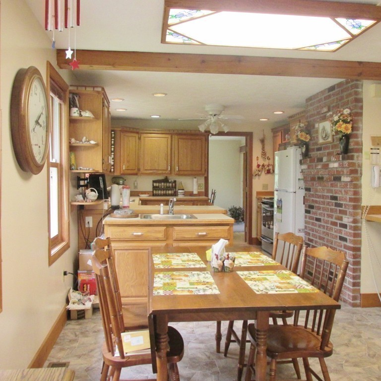 82 Little Turnpike Road Shirley, MA 01464 - Photo 16 of 27 a dining room with a table chairs and a kitchen view
