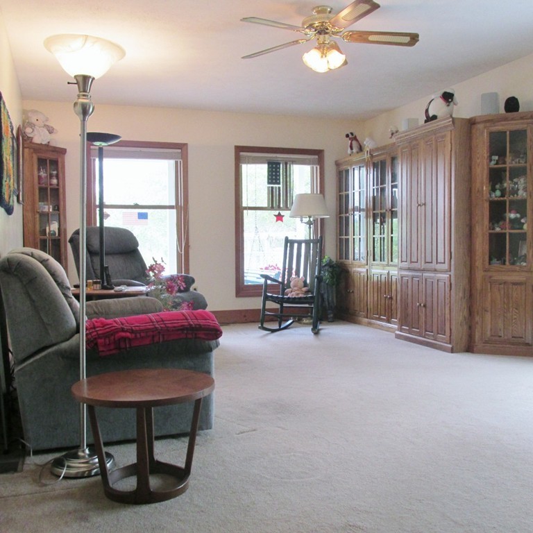 82 Little Turnpike Road Shirley, MA 01464 - Photo 19 of 27 a living room with furniture and a chandelier