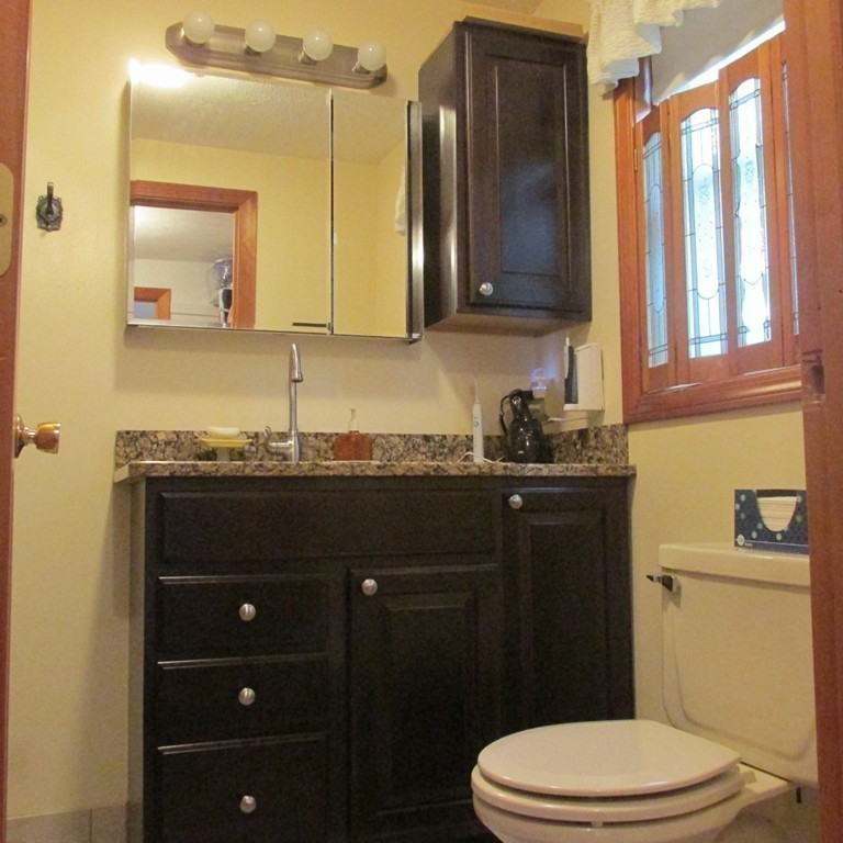 82 Little Turnpike Road Shirley, MA 01464 - Photo 26 of 27 a bathroom with a granite countertop sink toilet and mirror
