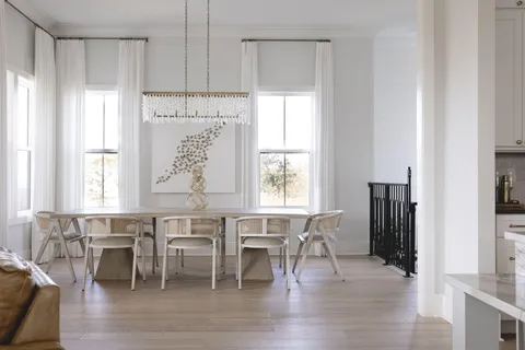a view of a a dining room with furniture window and wooden floor
