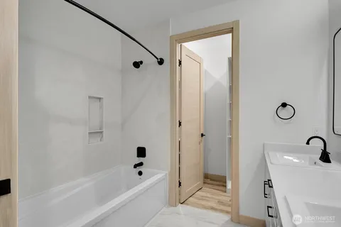 a bathroom with a bathtub and a shower