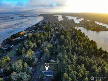 an aerial view of a house with a yard and lake view
