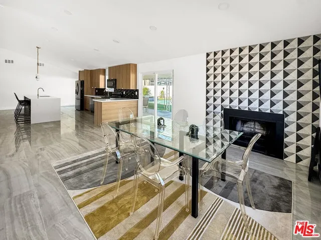 a living room with furniture a table and a large window