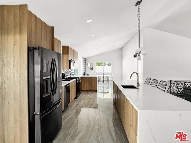 a view of living room kitchen with furniture and wooden floor