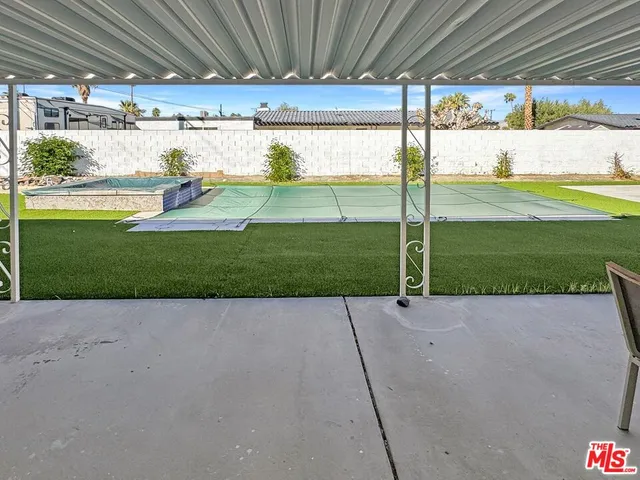 a view of a backyard with sitting area