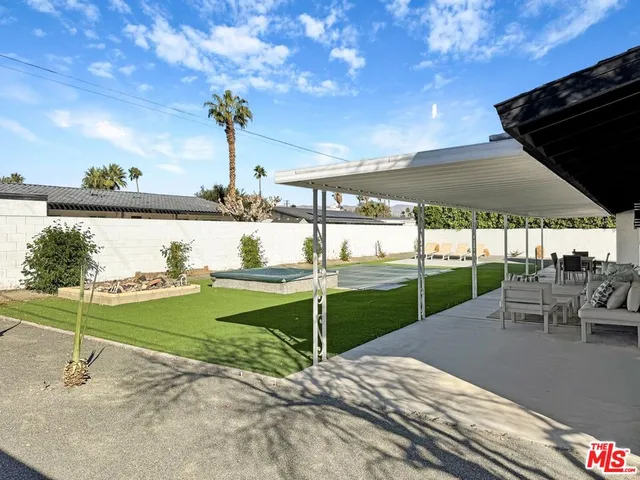 a view of a swimming pool with a lawn chairs