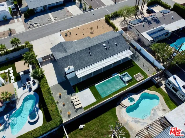 an aerial view of a house roof deck with furniture