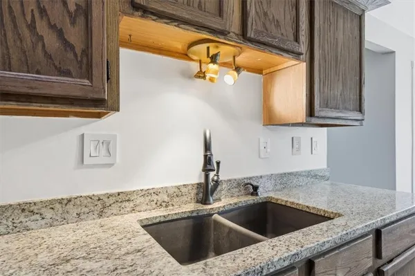 a kitchen with a sink and granite top