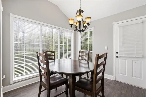 a view of a dining room with furniture window and wooden floor