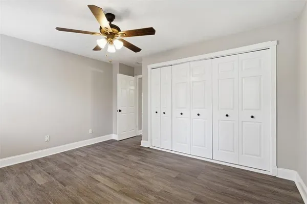 a view of an empty room with wooden floor