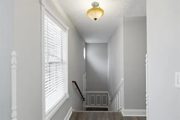 a view of an empty room and wooden floor
