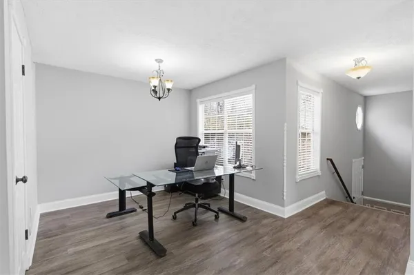 a view of a workspace with furniture and a window