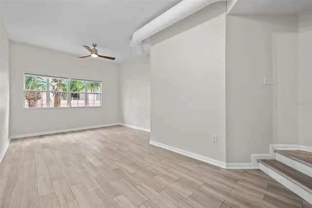 wooden floor in an empty room with a window