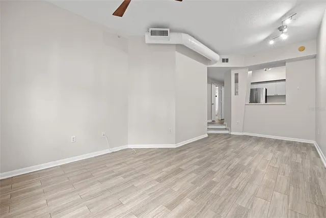a view of a room with wooden floor and window