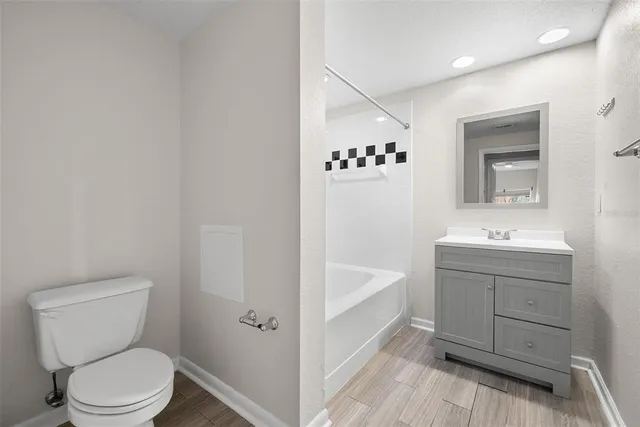 a bathroom with a sink vanity tub and a mirror