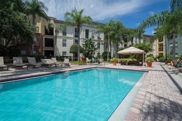 a swimming pool with outdoor seating and yard