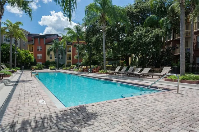 a front view of a house with swimming pool having outdoor seating