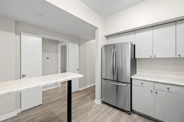 a kitchen with stainless steel appliances a refrigerator sink and microwave