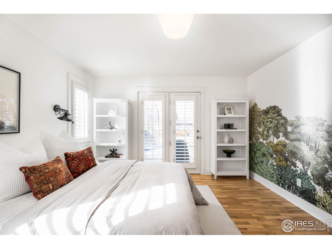 2543 Pine Street Boulder, CO 80302 - Photo 20 of 40 a bedroom with a bed lamp and a large window