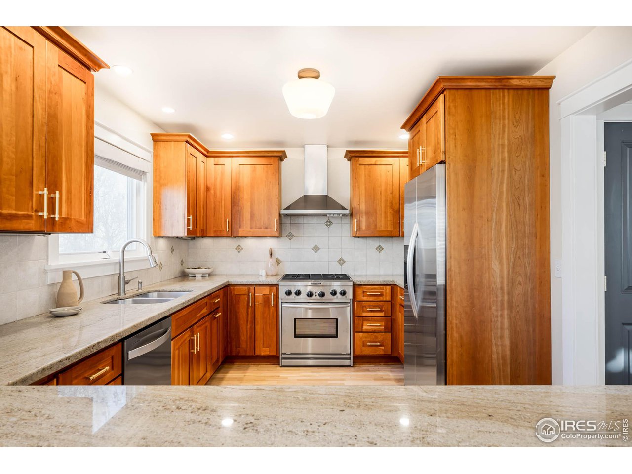 2543 Pine Street Boulder, CO 80302 - Photo 9 of 40 a kitchen with stainless steel appliances granite countertop a stove a sink and a microwave