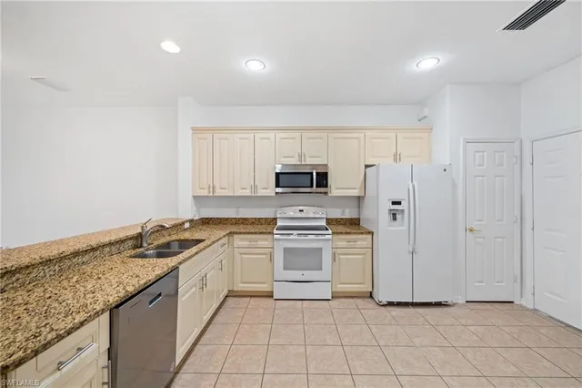 a kitchen with a stove a sink and a refrigerator