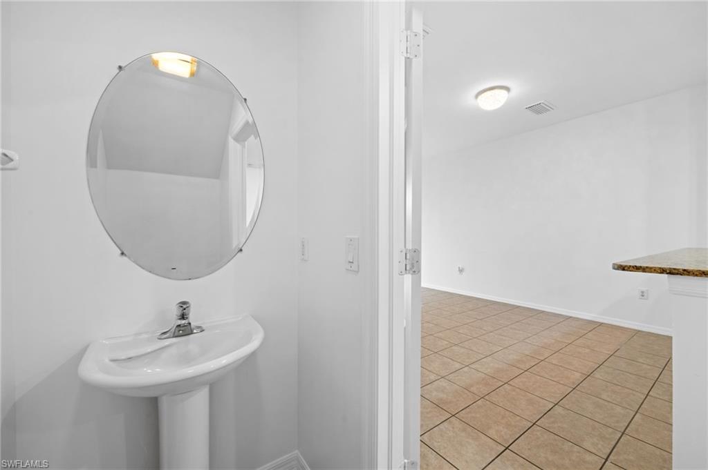 880 Hampton Circle, Unit 160 Naples, FL 34105 - Photo 15 of 32 a bathroom with a sink and a mirror