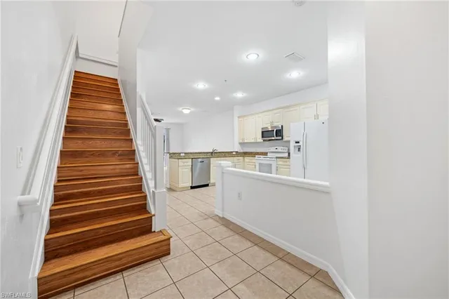 a view of kitchen with sink microwave and refrigerator
