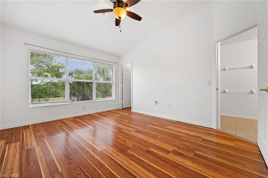 880 Hampton Circle, Unit 160 Naples, FL 34105 - Photo 18 of 32 wooden floor in an empty room with a window