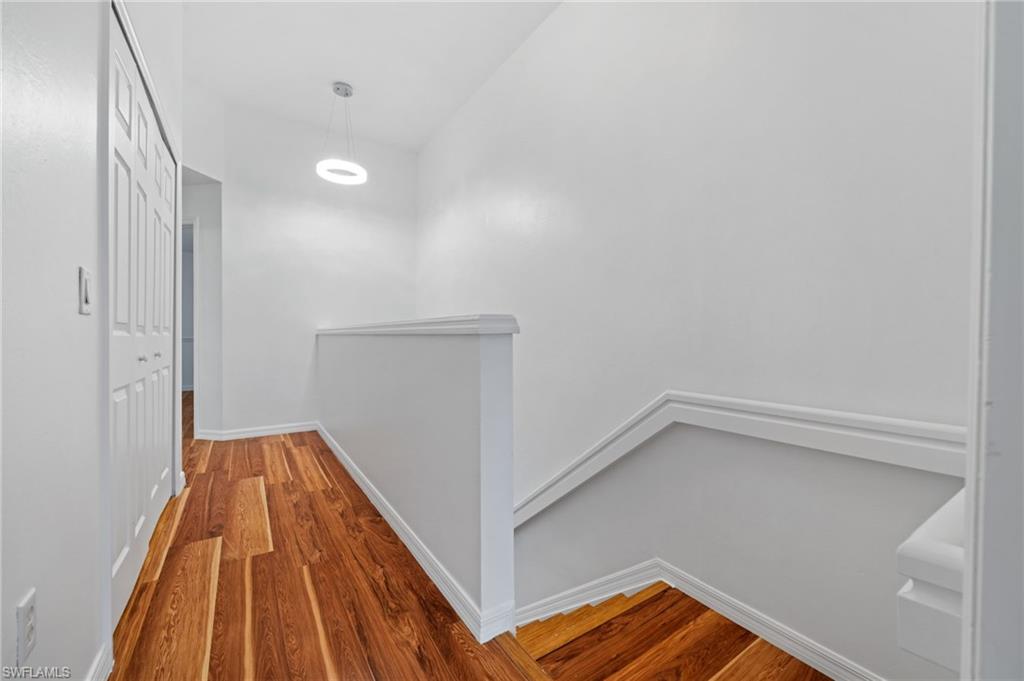 880 Hampton Circle, Unit 160 Naples, FL 34105 - Photo 21 of 32 a view of a hallway with wooden floor