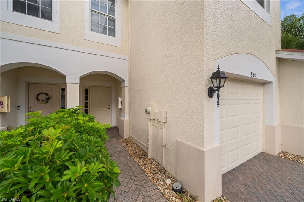 880 Hampton Circle, Unit 160 Naples, FL 34105 - Photo 28 of 32 a front view of a house with garden