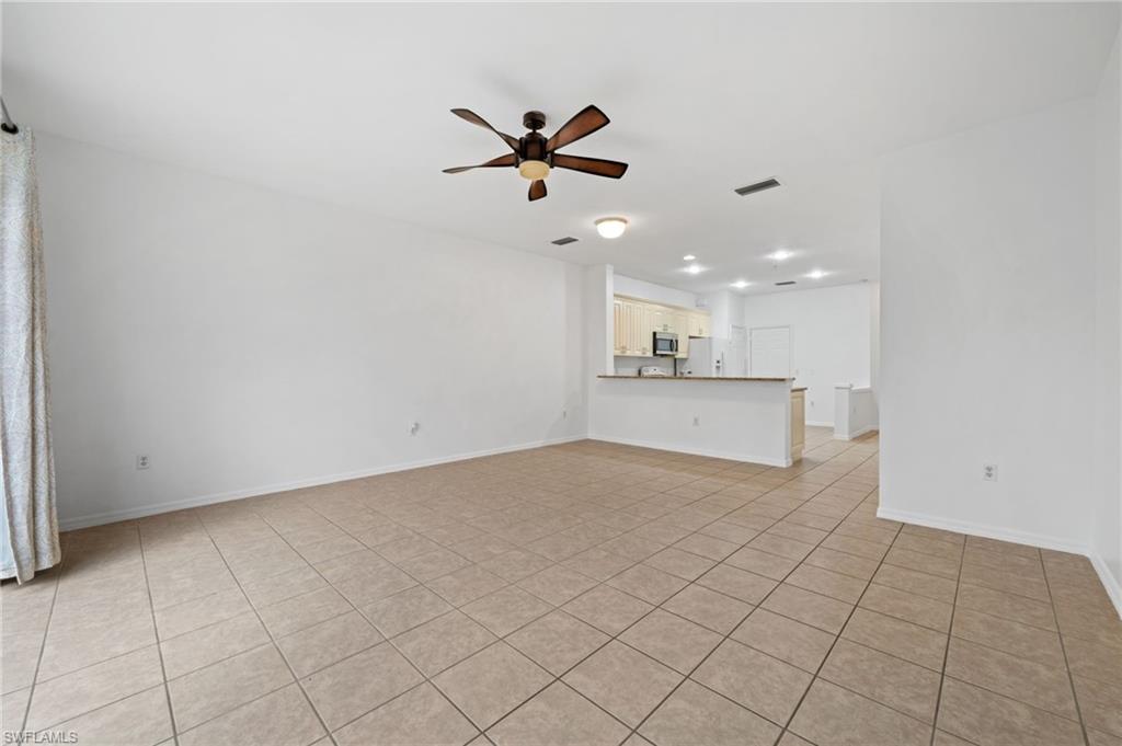 880 Hampton Circle, Unit 160 Naples, FL 34105 - Photo 10 of 32 a view of a kitchen with a sink and a chandelier fan