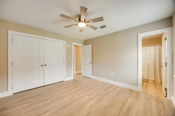 a view of an empty room with wooden floor