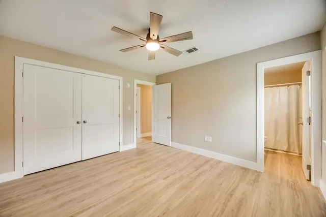 a view of an empty room with wooden floor
