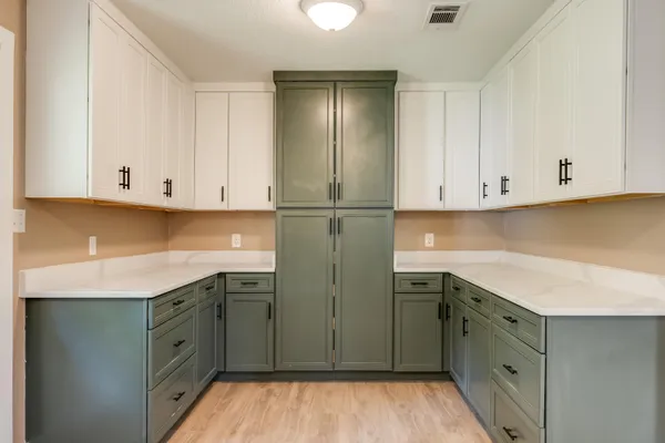 a kitchen with stainless steel appliances granite countertop a sink and cabinets