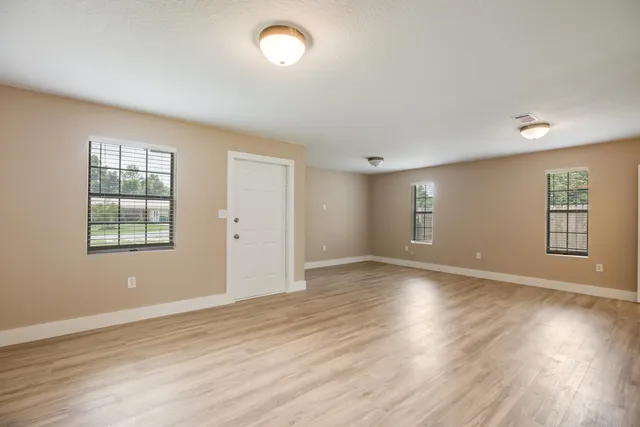 a view of kitchen and hall with wooden floor