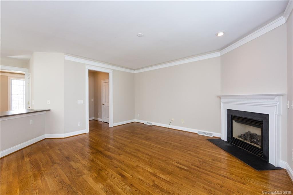 17530 Invermere Avenue Huntersville, NC 28078 - Photo 11 of 36 a view of empty room with wooden floor and fireplace