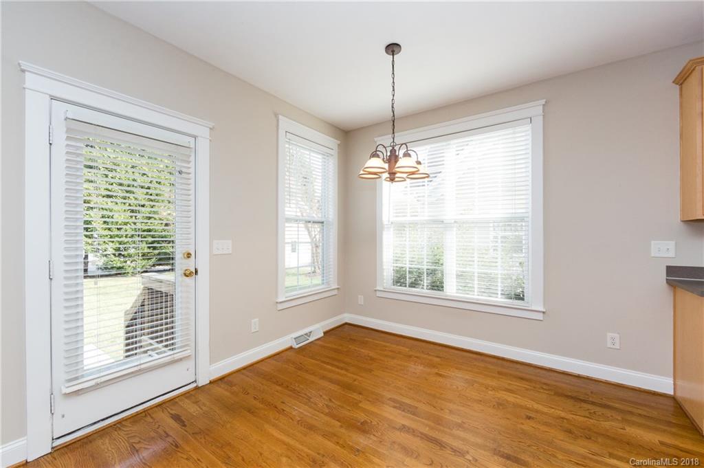 17530 Invermere Avenue Huntersville, NC 28078 - Photo 13 of 36 a view of an empty room with a window and wooden floor