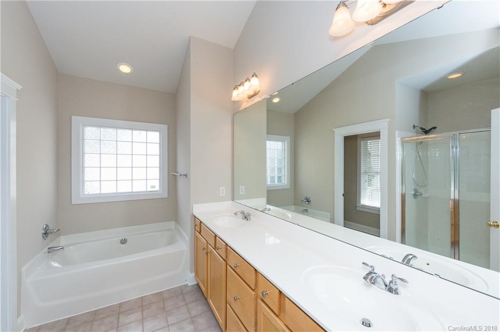 17530 Invermere Avenue Huntersville, NC 28078 - Photo 24 of 36 a bathroom with a bathtub double sink and mirror