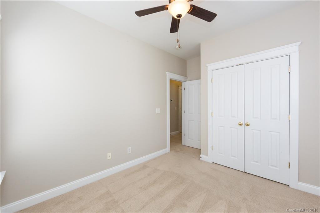 17530 Invermere Avenue Huntersville, NC 28078 - Photo 32 of 36 an empty room with a ceiling fan and a window